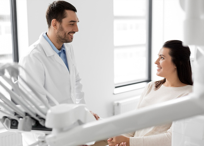 Dentist and patient smiling at each other