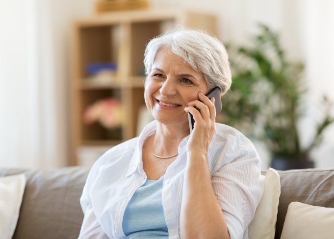 Woman sitting on couch speaking on the phone