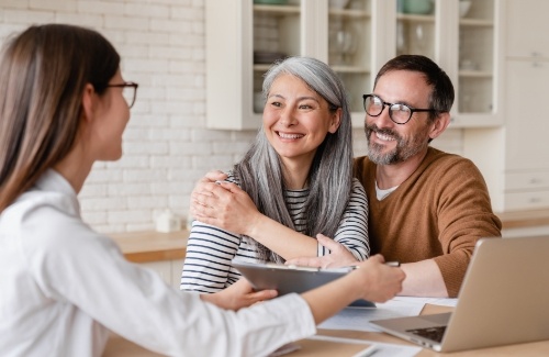 Couple discussing financing with dentist