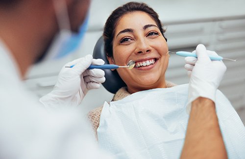 A dentist preparing to treat her patient