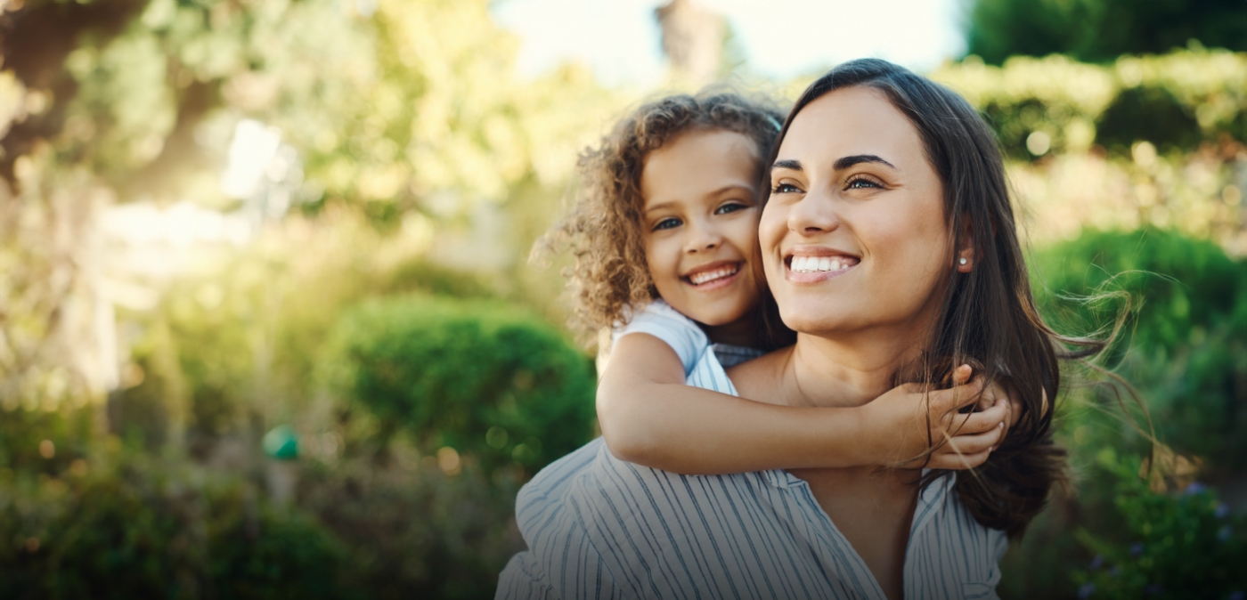 Woman giving a child a piggyback ride