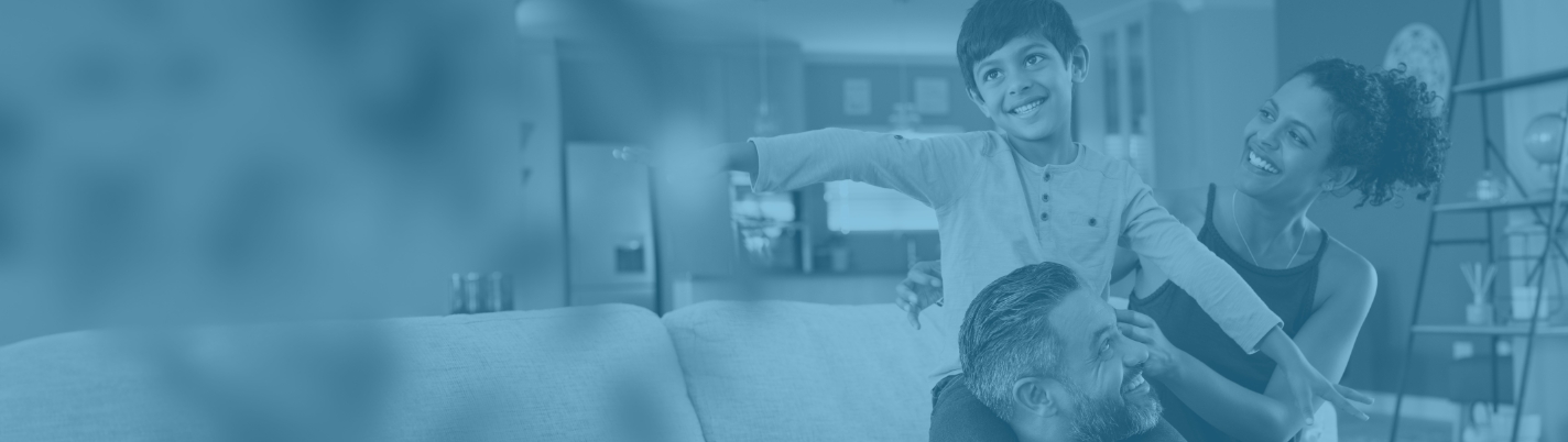 Smiling family of three sitting on couch