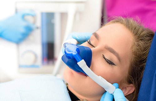 A young woman receiving nitrous oxide sedation